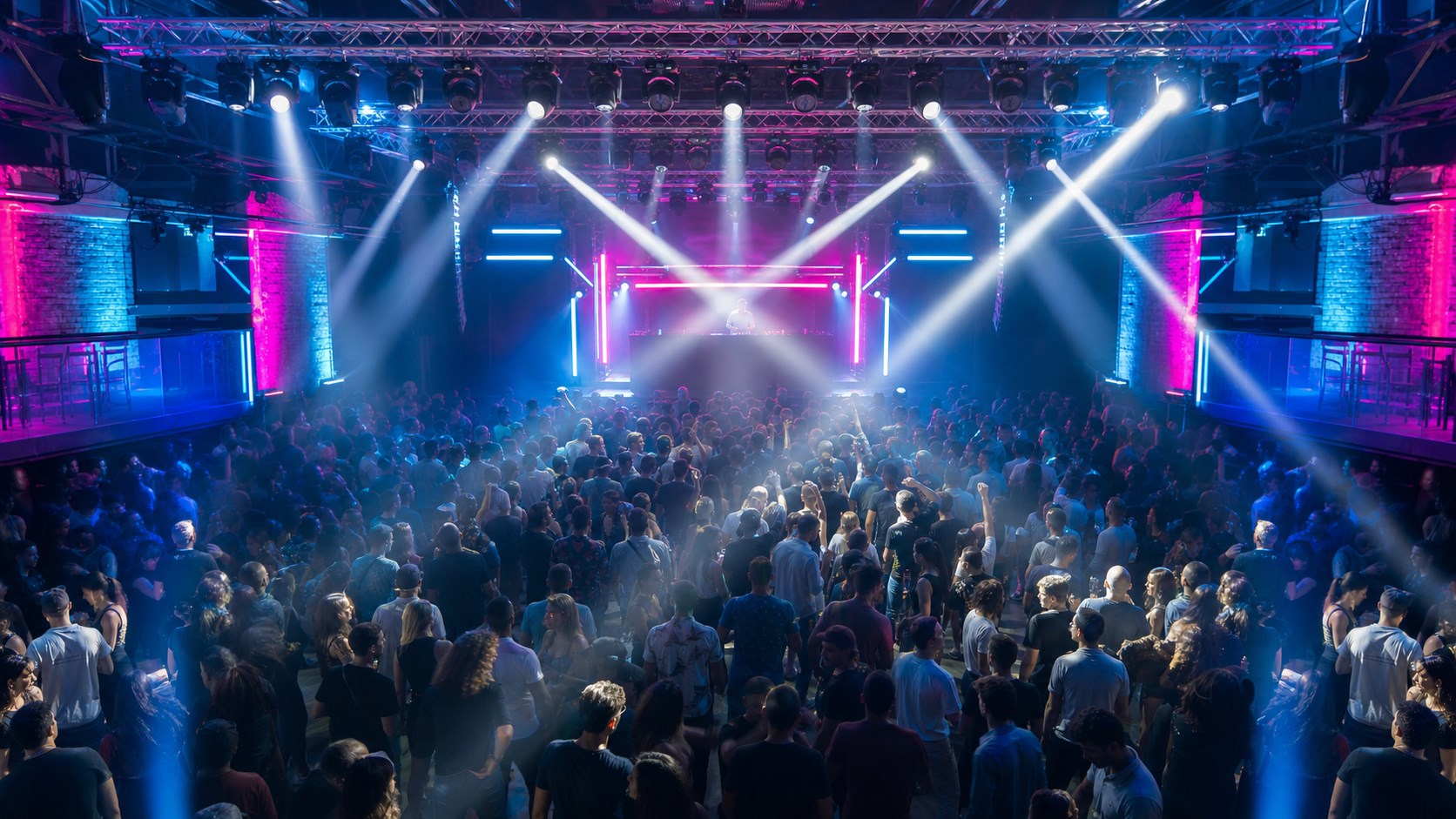 Professional club DJ lighting setup with moving head beams over a 500-person dance floor